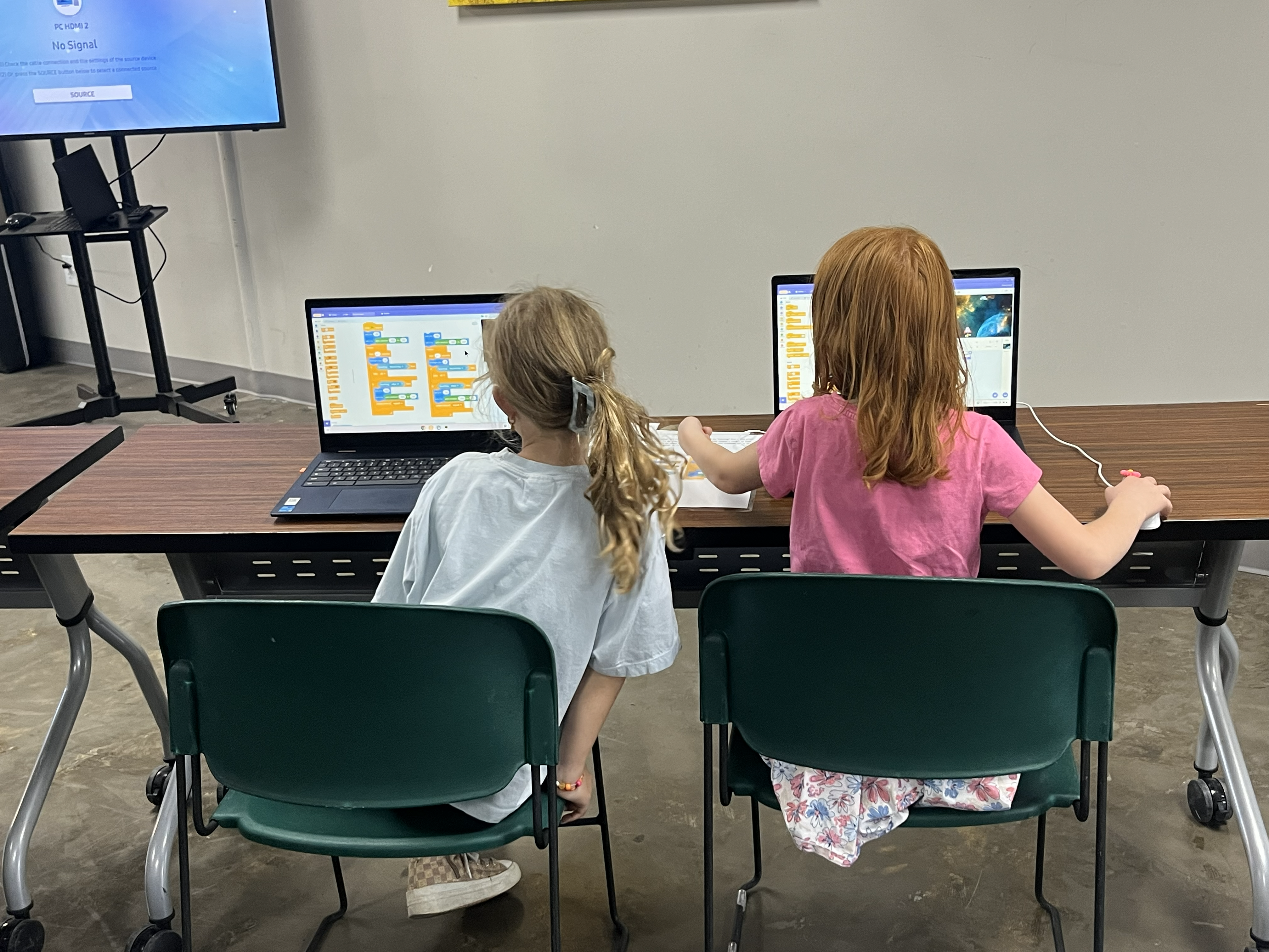 Two students coding together